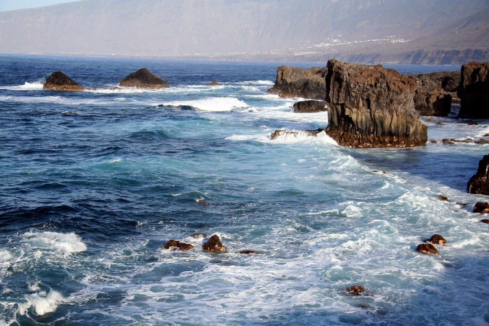 The rugged volcanic coast of the El Golfo valley, home to the La Maceta rock pools, on El Hierro