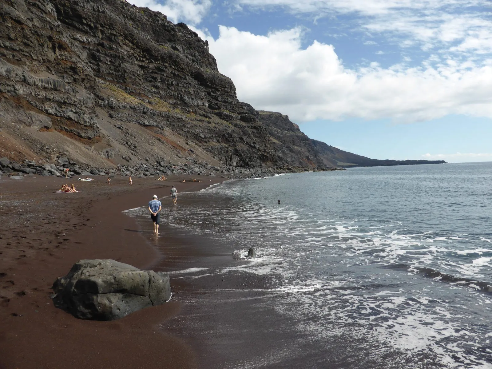 The reddish volcanic sand of Playa del Verodal backed by cliffs on the west coast of El Hierro