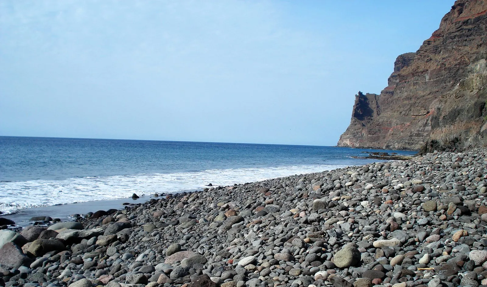 The isolated cliff-backed beach of Güigüí, reachable only on foot or by boat, on western Gran Canaria