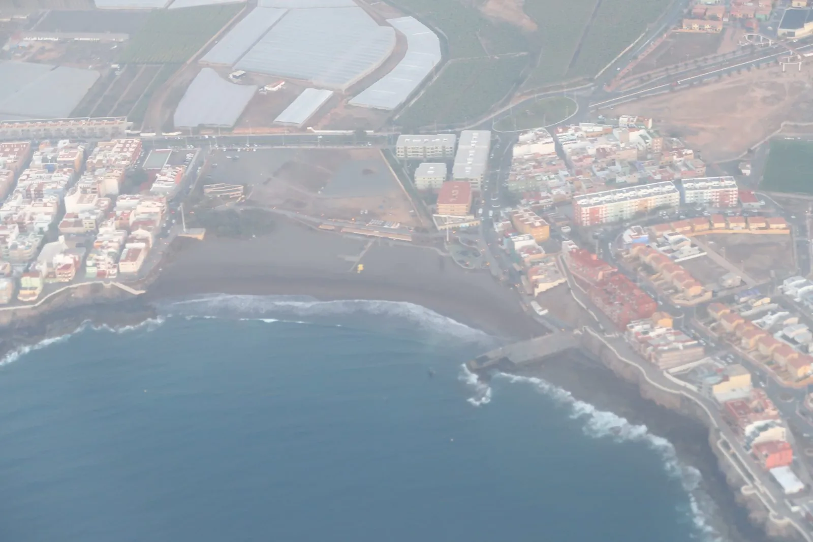 The dark-sand bay of Playa de Melenara near Telde on the east coast of Gran Canaria