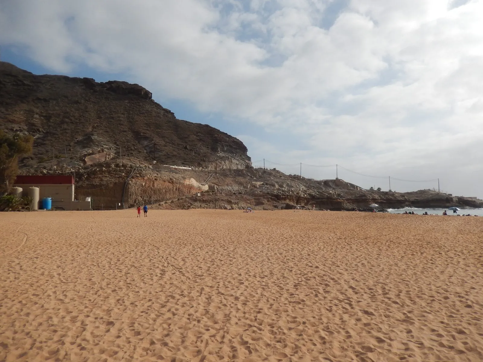 Sunbeds and mountains framing Playa de Tauro, Gran Canaria
