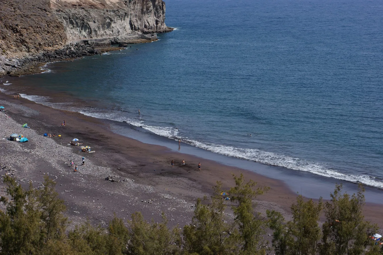 The remote pebble and sand beach of Playa de Veneguera on Gran Canaria's wild west coast