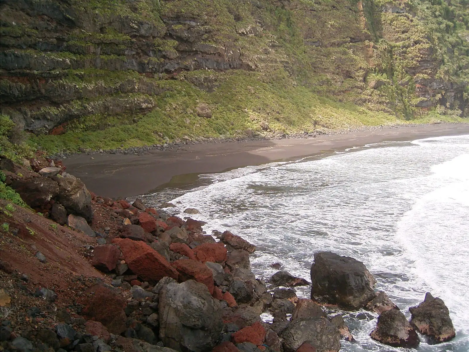 Cliffs backing the remote volcanic beach of Playa de Nogales, La Palma