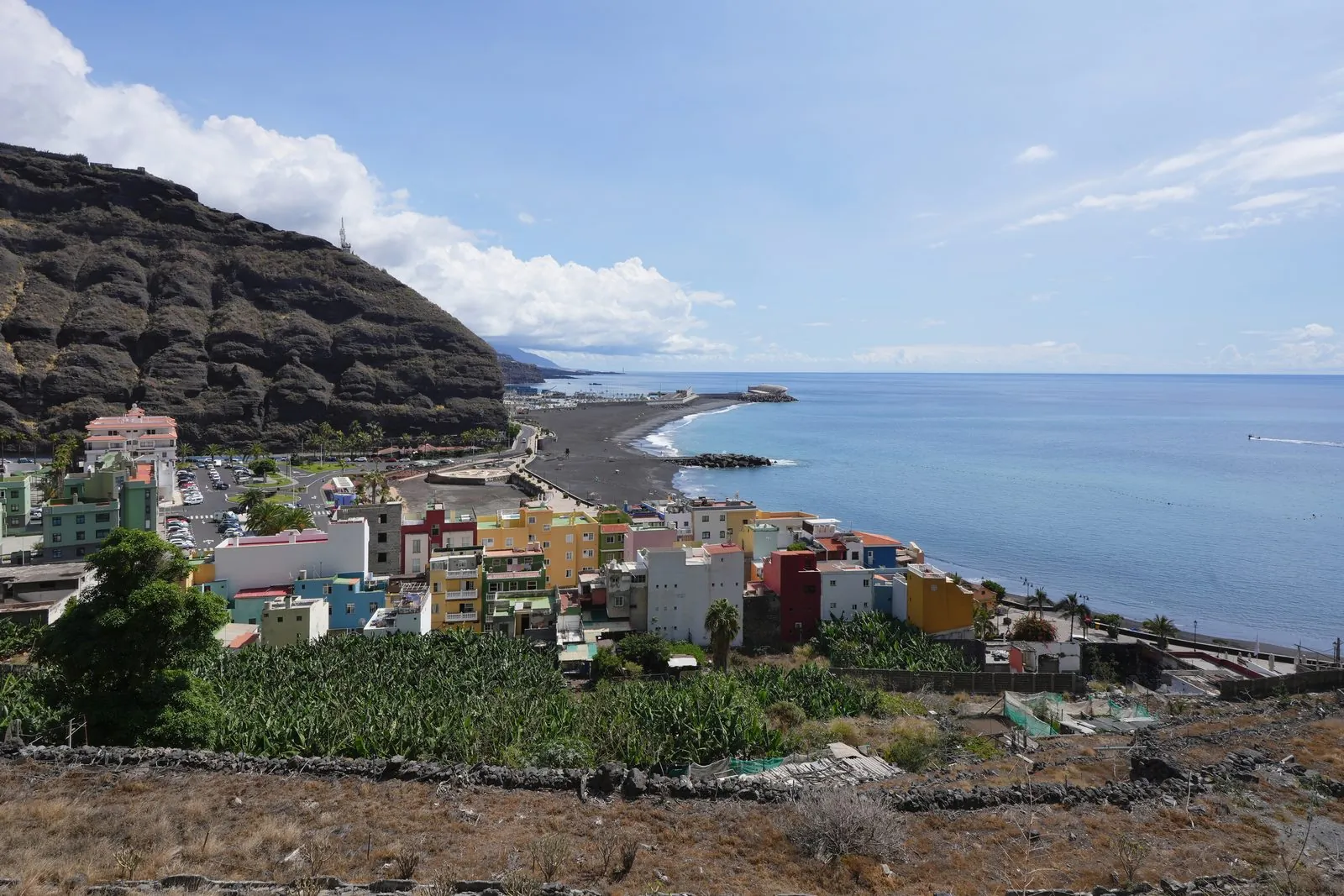 The harbour and black-sand beach of Puerto de Tazacorte seen from above, western La Palma