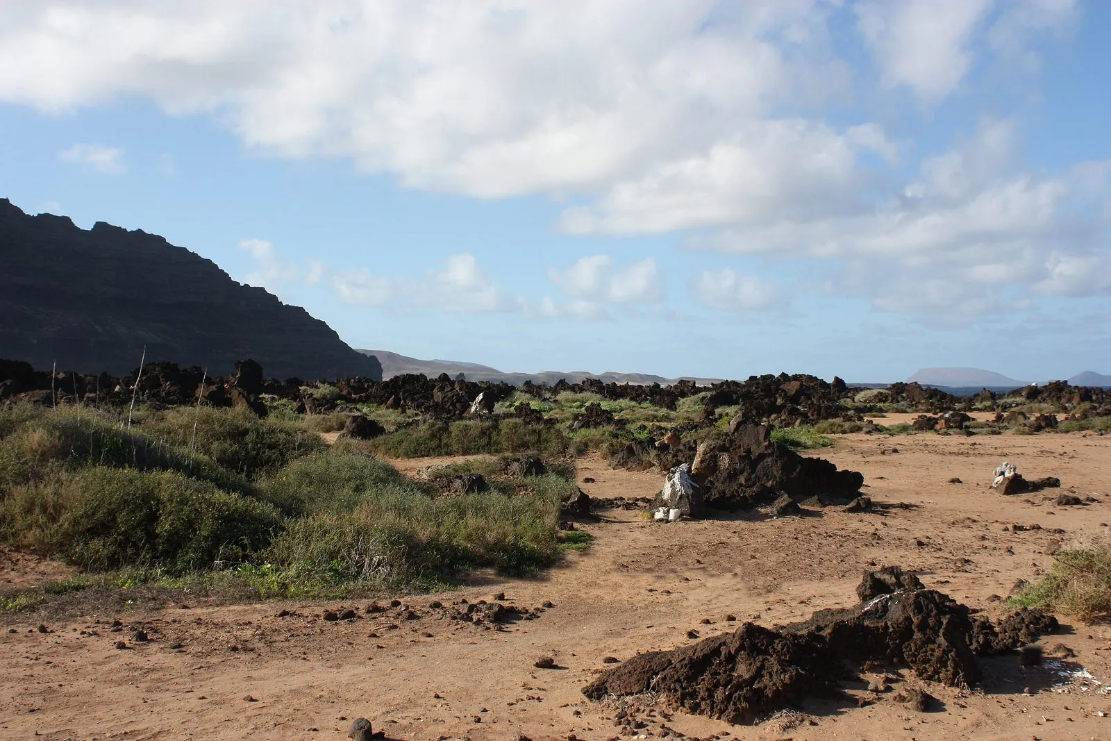 Turquoise shallows between lava and white sand at Caletón Blanco, Órzola, Lanzarote