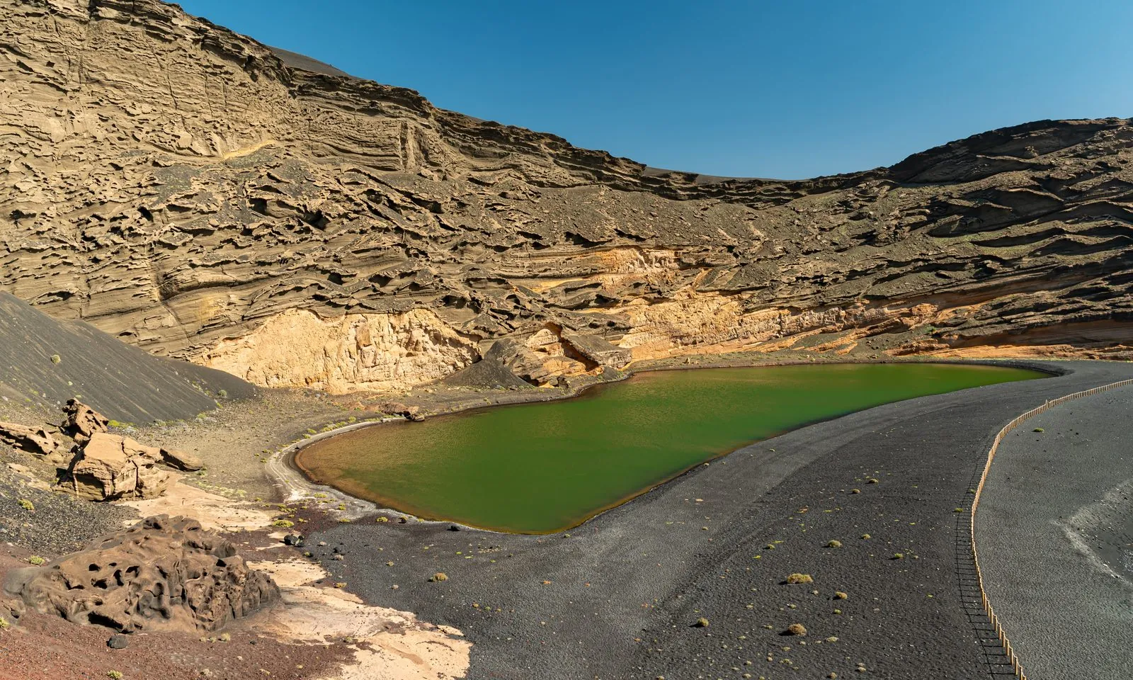 The green Charco de los Clicos lagoon and black beach at El Golfo, Lanzarote