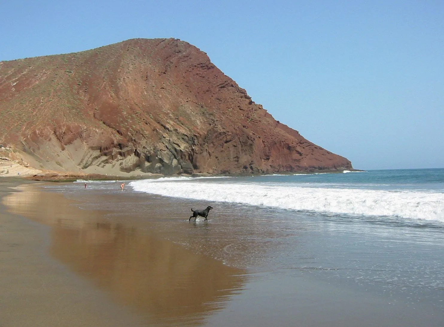 The long natural beach of La Tejita beneath the red cone of Montana Roja, Tenerife