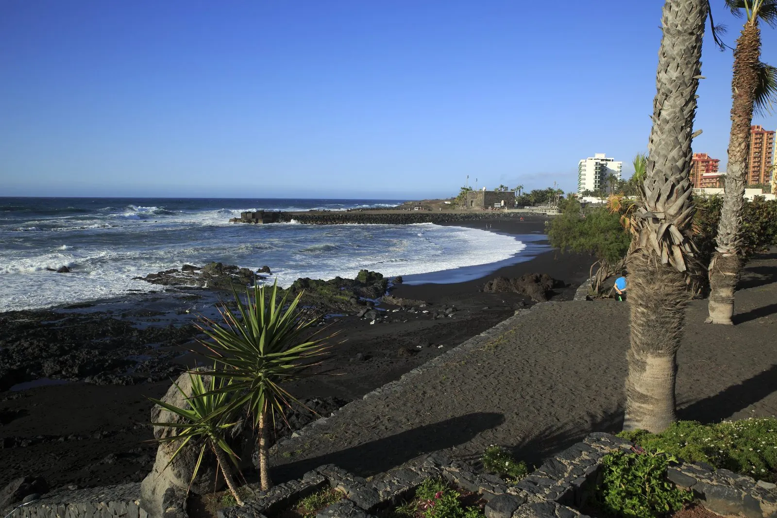 Volcanic sand and surf along Playa Jardin in Puerto de la Cruz, Tenerife