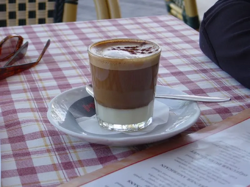 A tall glass of barraquito coffee served in a bar in Tenerife