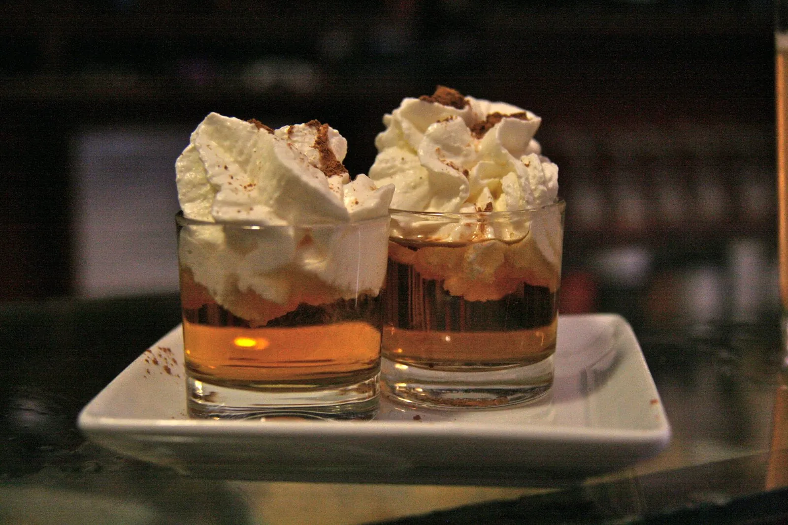 A shot of ron miel, the Canarian honey rum, topped with cream and cinnamon
