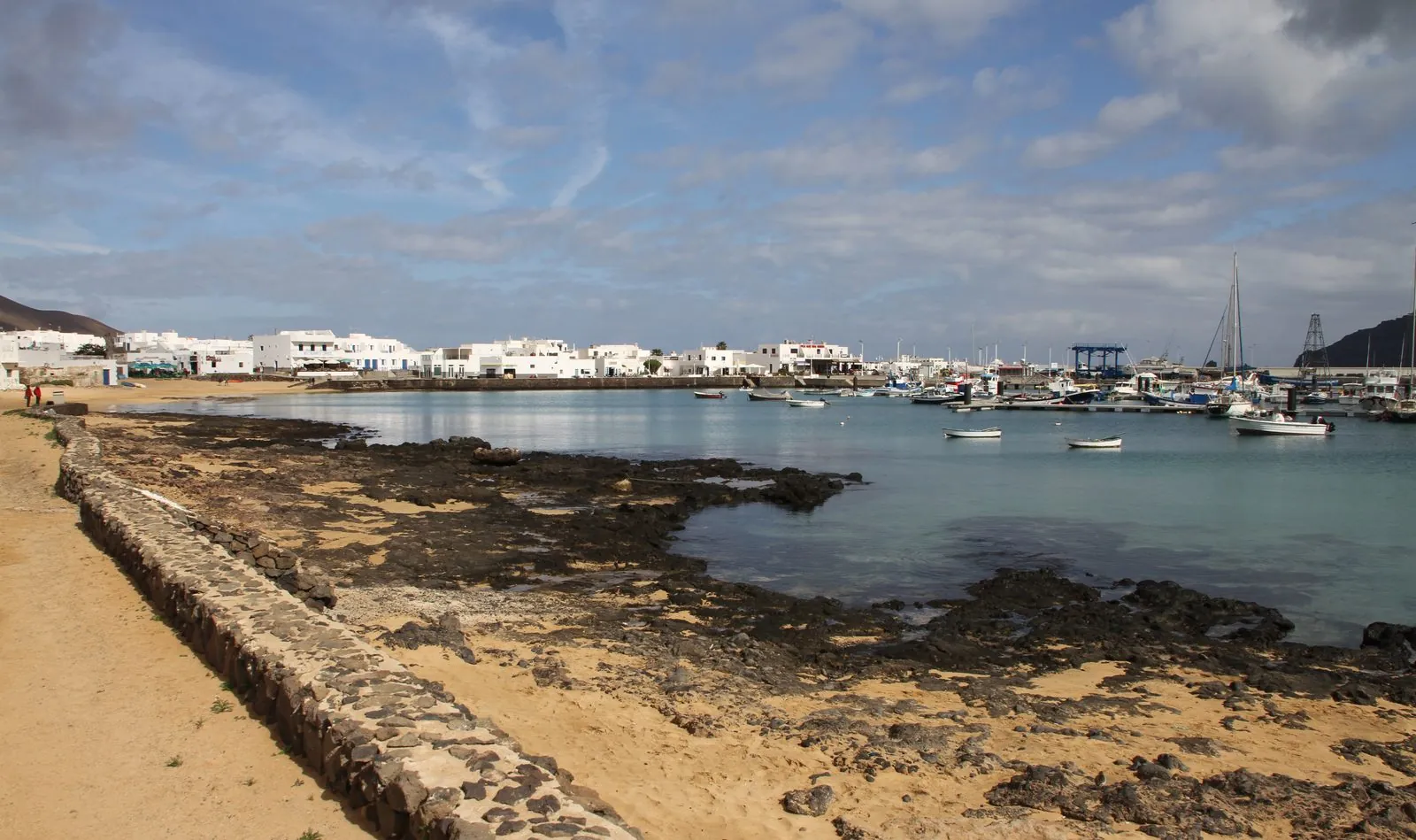 The harbour and low white houses of Caleta de Sebo, the main village of La Graciosa