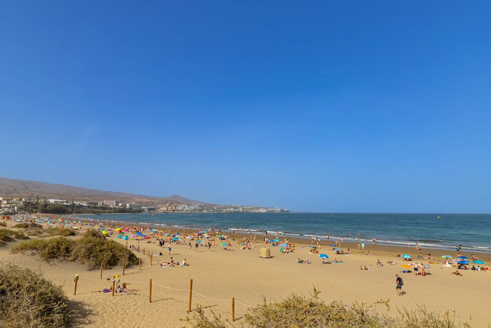 Sunbathers on El Veril beach beside the Maspalomas dunes, southern Gran Canaria