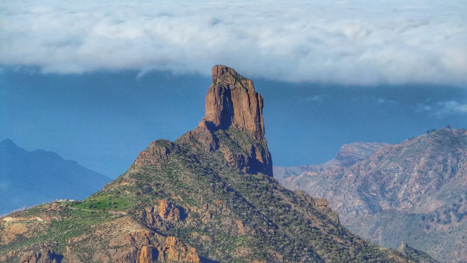 A trade-wind sea of clouds spilling over the highlands around Roque Bentayga on Gran Canaria