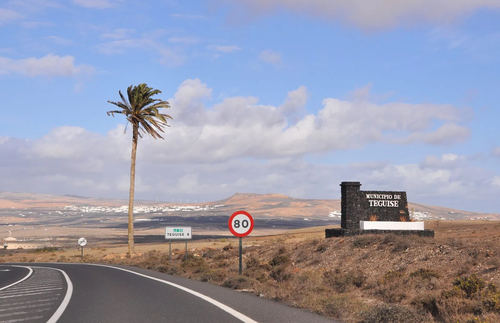 An open road across the volcanic landscape of Lanzarote near Teguise