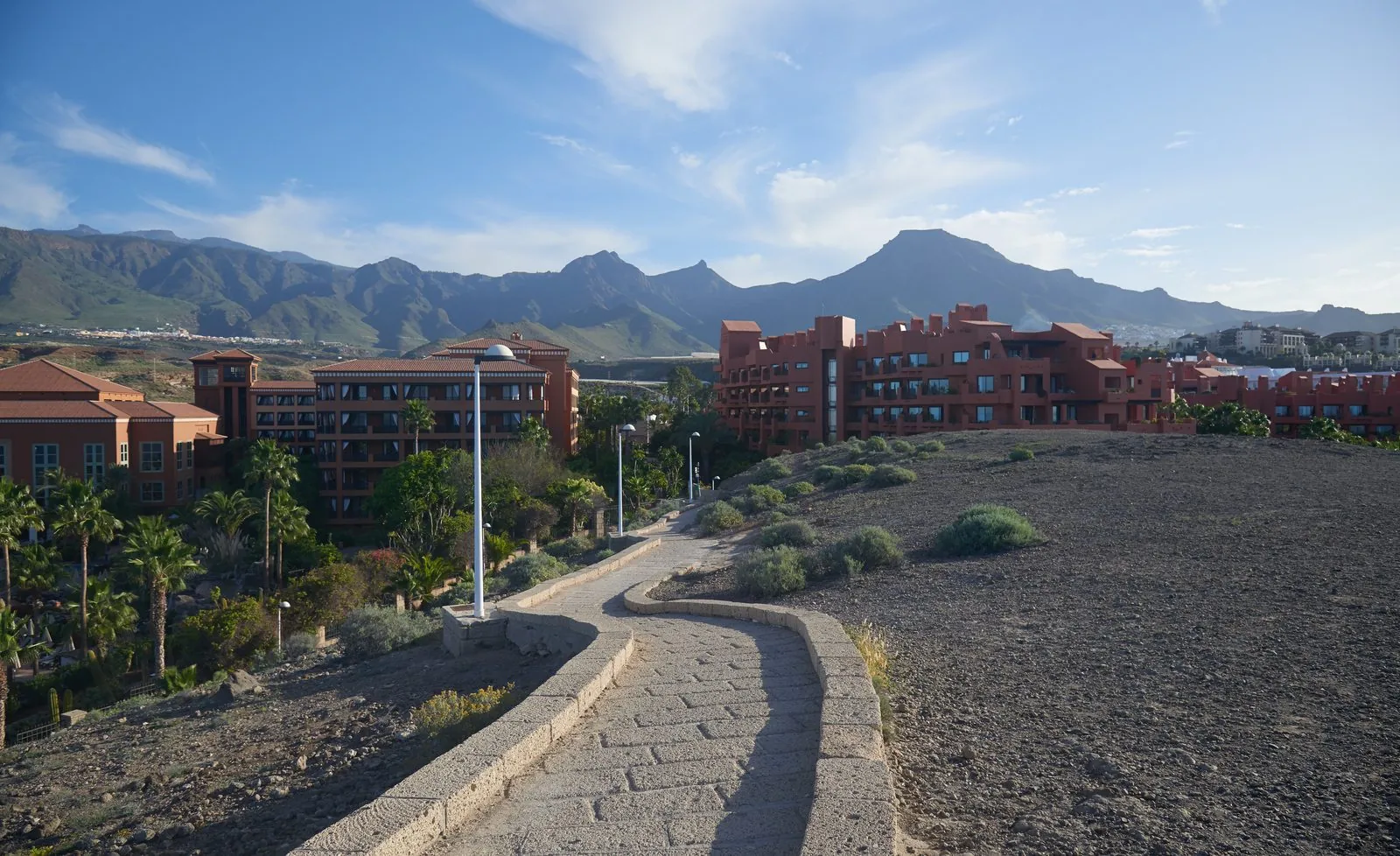 Resort hotels lining the seafront at Costa Adeje below the mountains of southern Tenerife