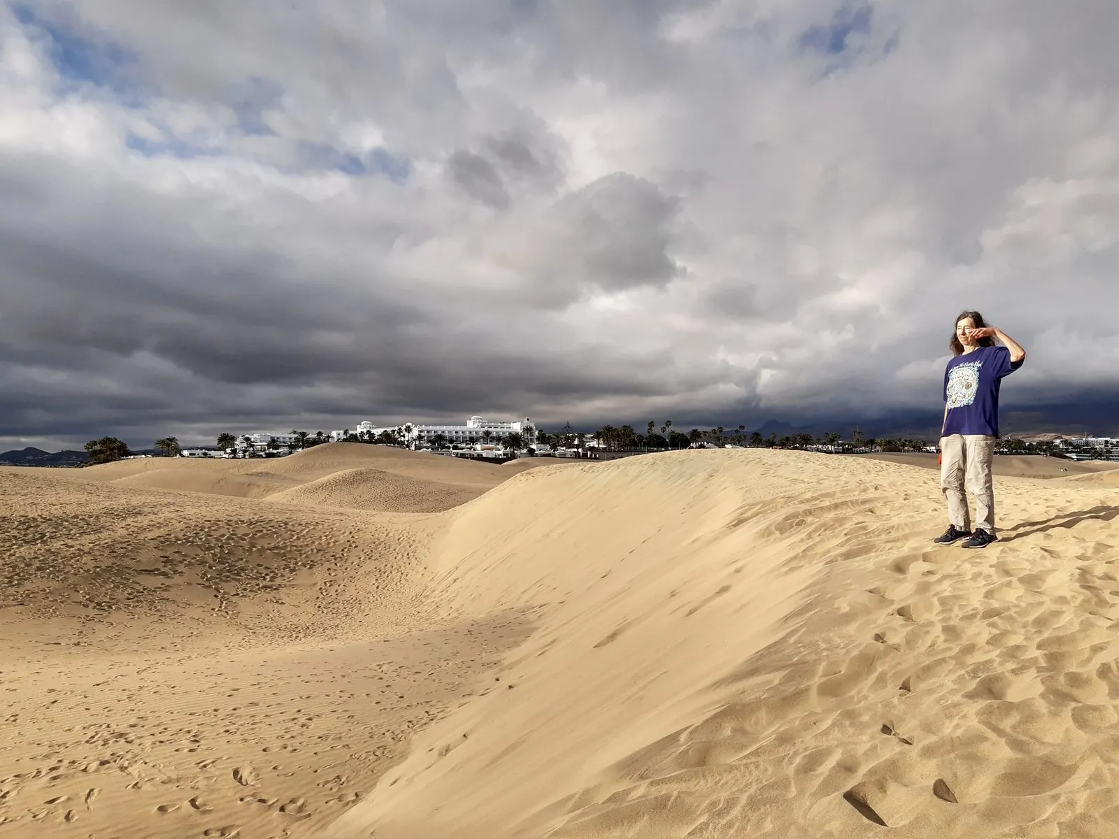 Resort hotels of Playa del Ingles seen across the edge of the Maspalomas dunes, Gran Canaria