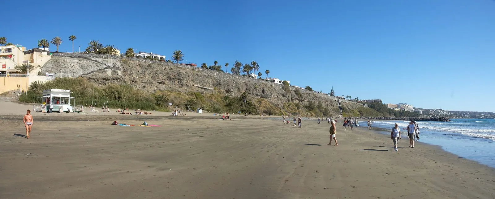 The wide golden sands and sunbathers of the beach at Playa del Ingles, Gran Canaria