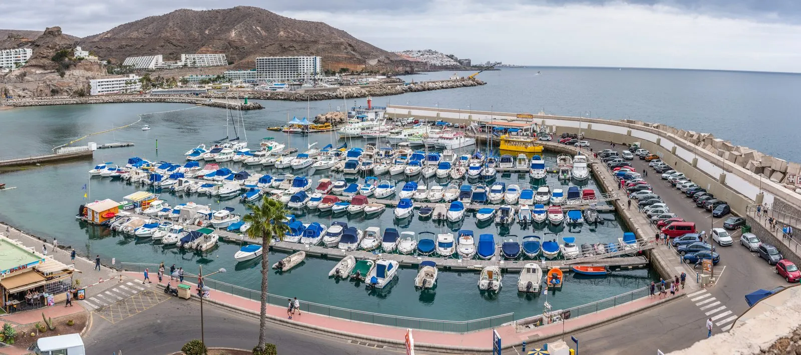 Apartments and marina of the Puerto Rico resort climbing the valley slopes, Gran Canaria