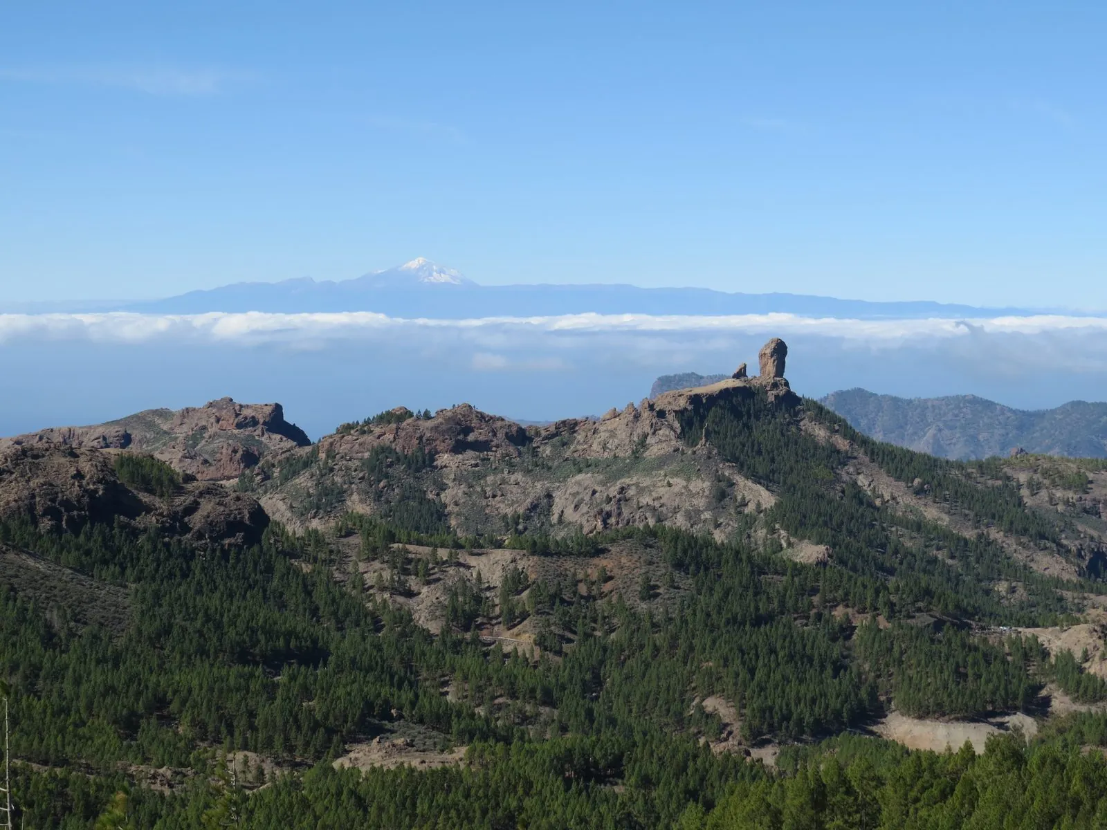 The rock monolith of Roque Nublo, with Mount Teide on Tenerife in the far distance