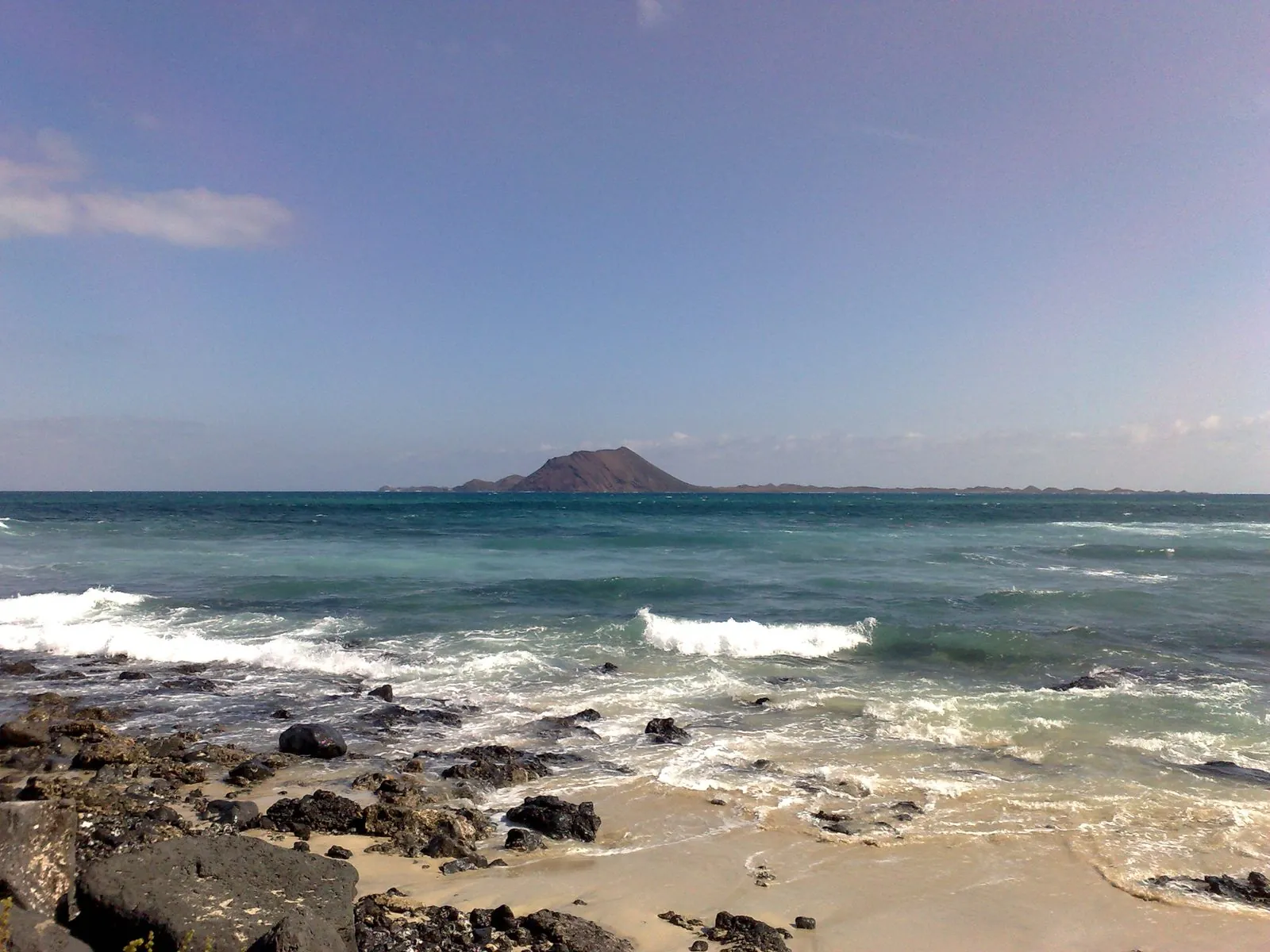 The low volcanic islet of Isla de Lobos seen across the water from Fuerteventura