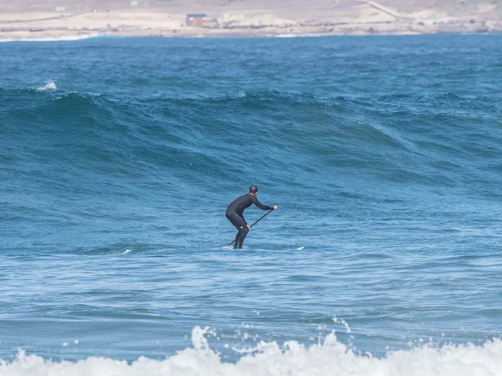 Stand-up paddleboarding in the calm water off Gran Canaria