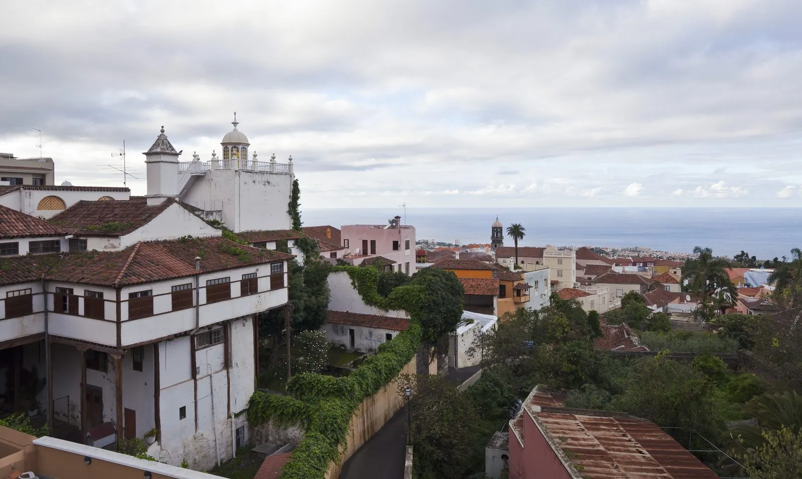 Rooftops and church towers of the historic town of La Orotava sloping down towards the sea, Tenerife