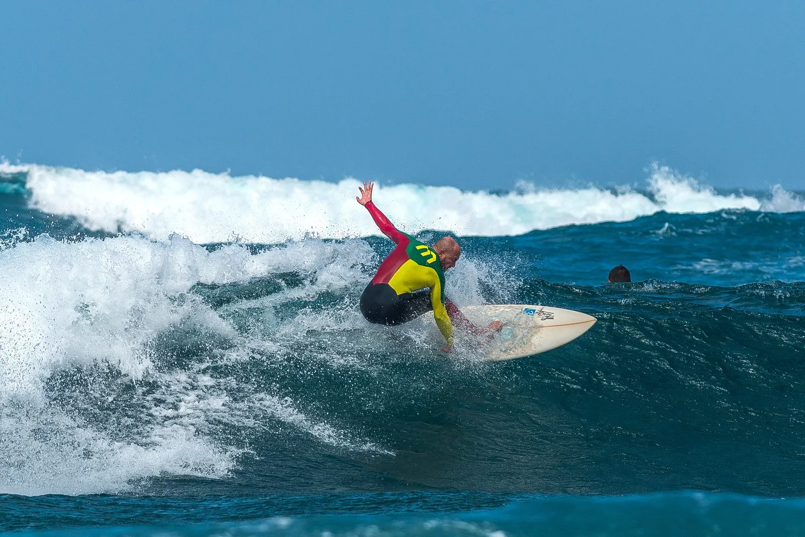 A surfer riding a breaking wave off the north shore of Fuerteventura in the Canary Islands